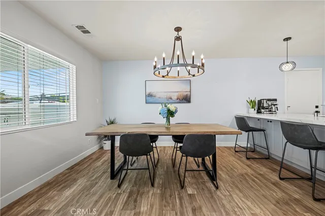 a view of a dining room with furniture wooden floor and chandelier