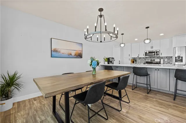 a view of a dining room with furniture wooden floor and chandelier