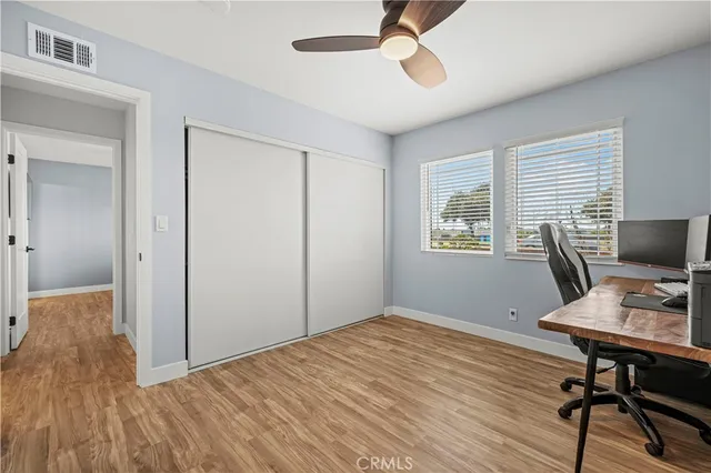 a workspace with wooden floor and a window