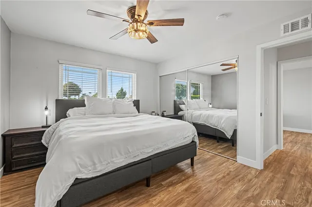 a bathroom with a toilet sink vanity granite and shower