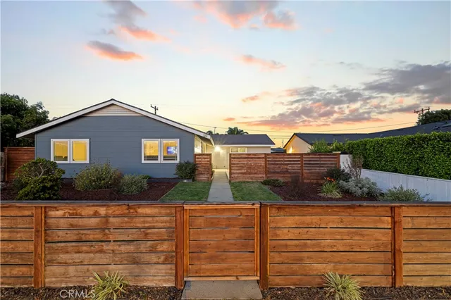a view of house with backyard and garden