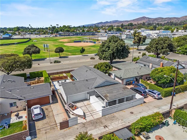 an aerial view of a house with garden space and ocean view
