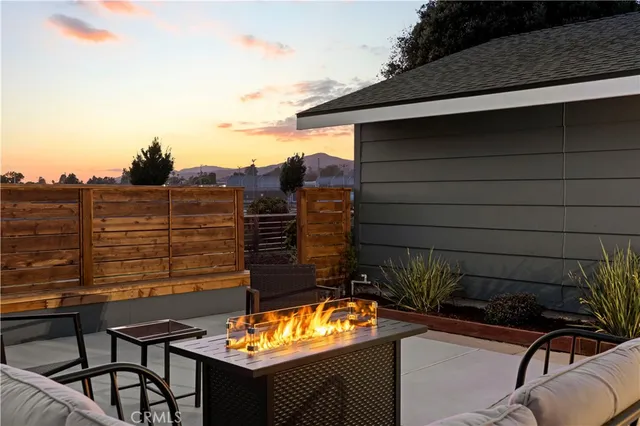 a view of a chairs and table in the balcony