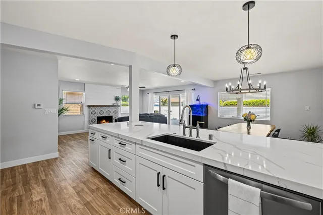 a kitchen with kitchen island white cabinets and wooden floor
