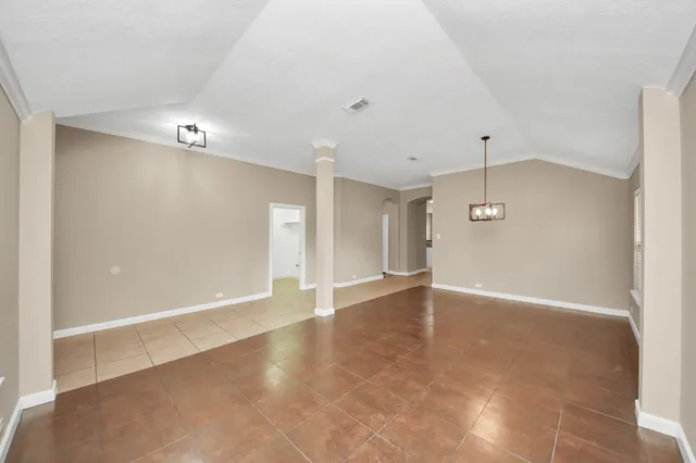 an empty room with a empty space and windows