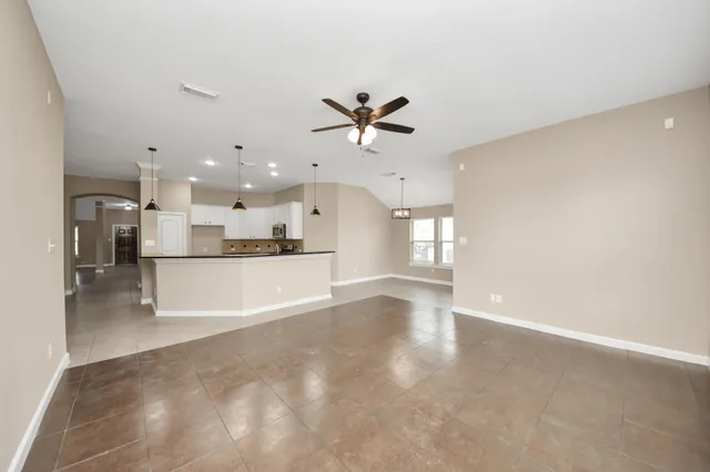 a view of a kitchen with a sink and a refrigerator