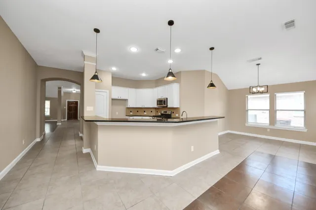 a large kitchen with stainless steel appliances kitchen island a large island in the center