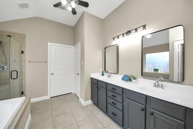 a spacious bathroom with a double vanity sink mirror and double