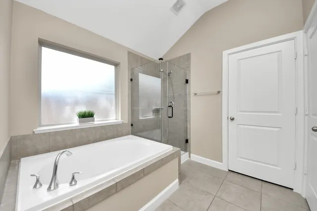 a bathroom with a tub and a window