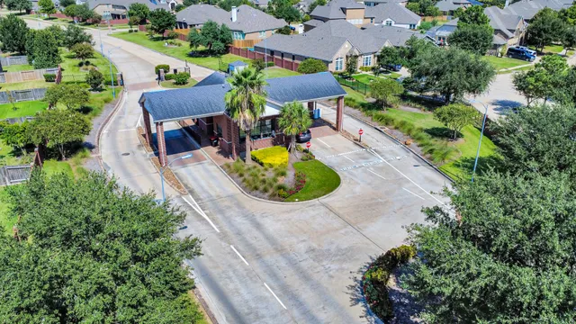 an aerial view of a house with a garden and trees