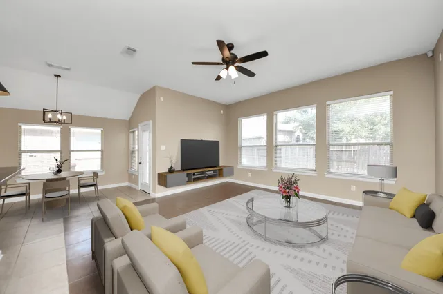 a living room with furniture and a flat screen tv