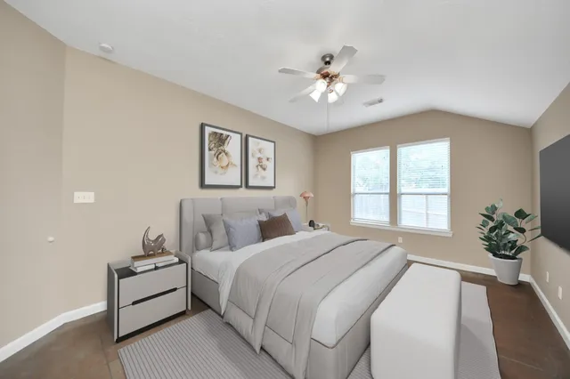a spacious bedroom with a bed and a chandelier