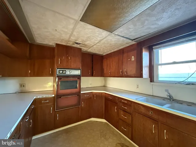 a kitchen with a sink cabinets and window