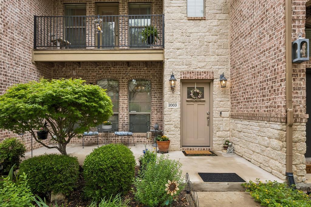 2003 Downing Street Allen, TX 75013 - Photo 5 of 40 The charming entry has beautiful architectural accents and the landscaped front patio offers a warm, welcoming, and refined first impression.
