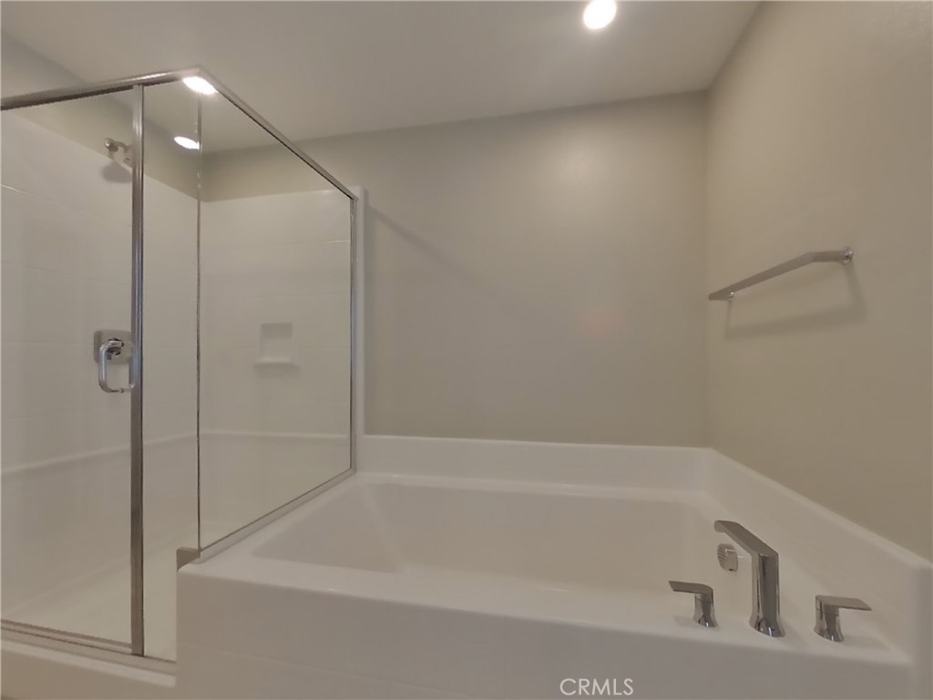 28201 Cookhouse Lane Menifee, CA 92584 - Photo 6 of 32 a bathroom with a bathtub and a shower