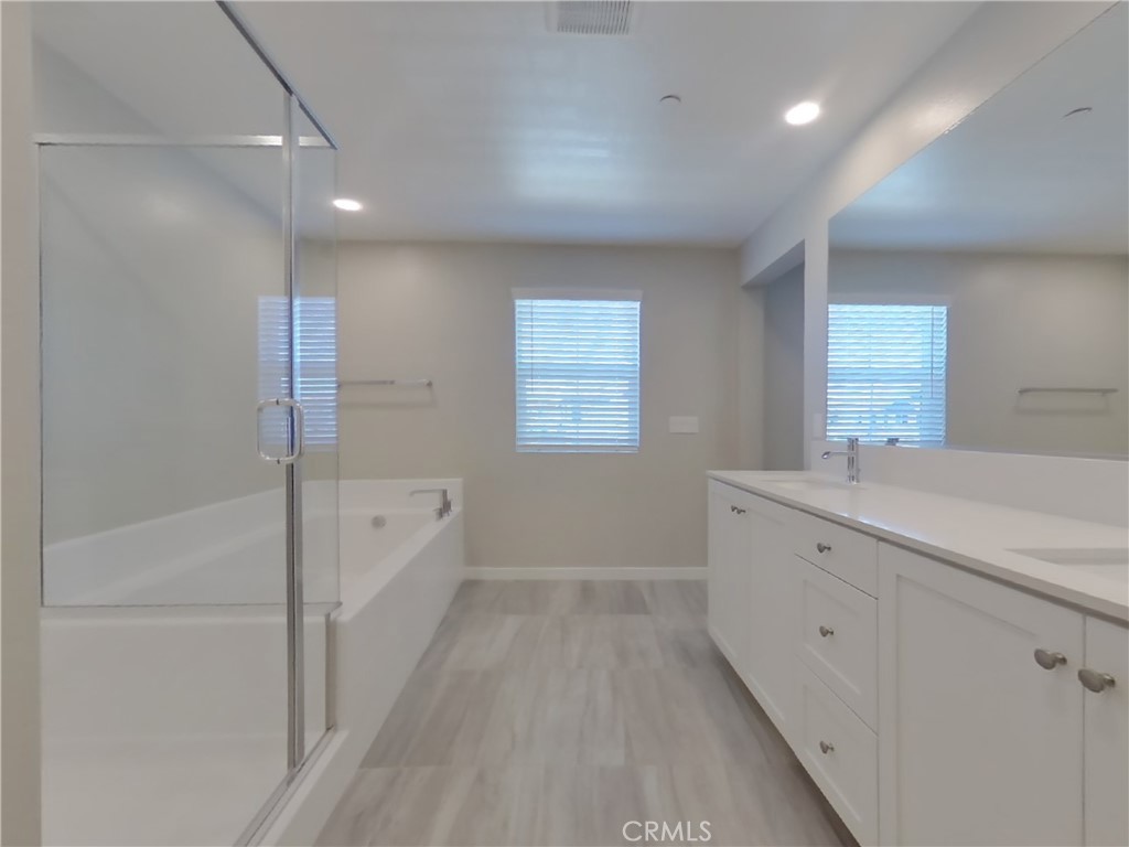 28201 Cookhouse Lane Menifee, CA 92584 - Photo 7 of 32 a bathroom with a tub sink and mirror