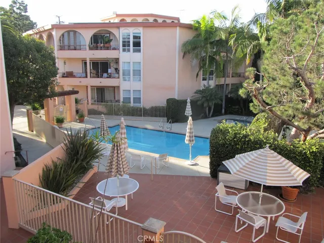 a view of a patio with couches table and chairs and potted plants