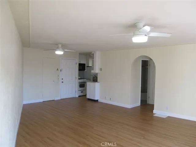 a view of a room with wooden floor and window
