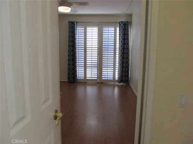 a view of a livingroom with wooden floor and a window