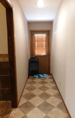 a bathroom with a granite countertop sink a mirror and shower
