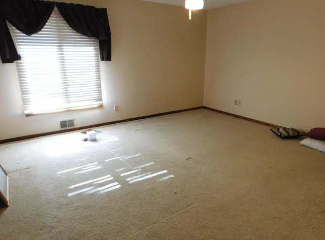 a kitchen with sink refrigerator and window