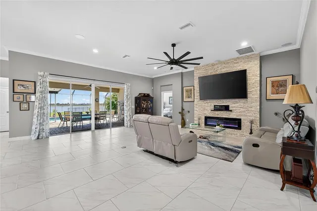 a dining room with furniture potted plants and a chandelier
