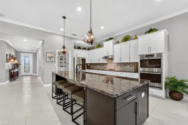 a white toilet sitting next to a white wall
