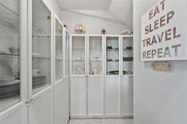 a white toilet sitting next to a white wall