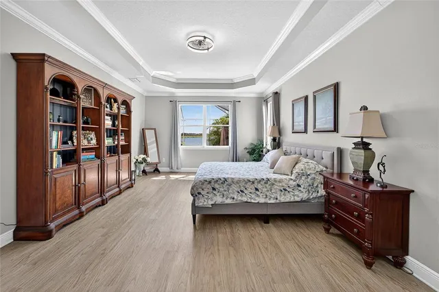 a bedroom with a large bed and a large window