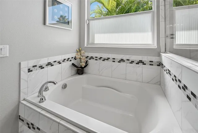 a view of a patio with table and chairs under an umbrella
