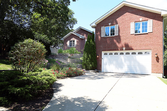 646 Robin Ridge Elgin, IL 60123 - Photo 2 of 24 a front view of a house with a yard and garage