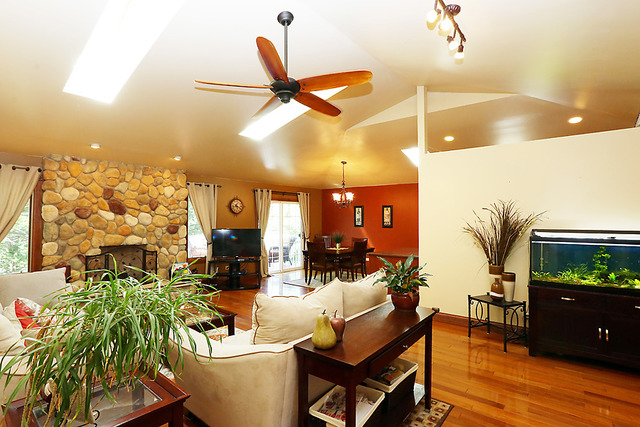 646 Robin Ridge Elgin, IL 60123 - Photo 4 of 24 a living room with couches and potted plants with wooden floor