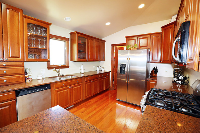 646 Robin Ridge Elgin, IL 60123 - Photo 6 of 24 a kitchen with stainless steel appliances granite countertop a sink stove and refrigerator