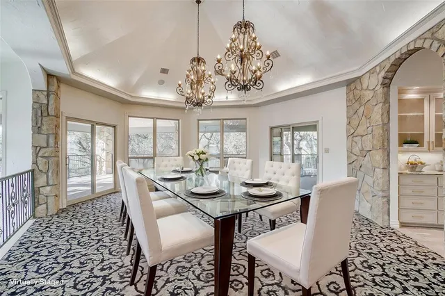a view of a dining room with furniture wooden floor and chandelier