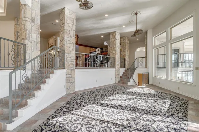 a view of a hallway with wooden floor and a living room