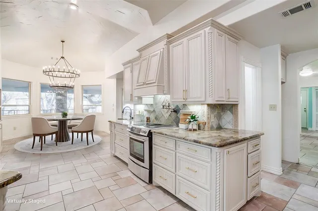 a kitchen with a white cabinets and window