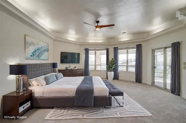 a spacious bedroom with a large bed and a tv