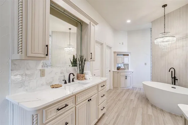 a bathroom with a double vanity sink a mirror and a bathtub