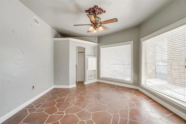 a view of a livingroom with a ceiling fan and window