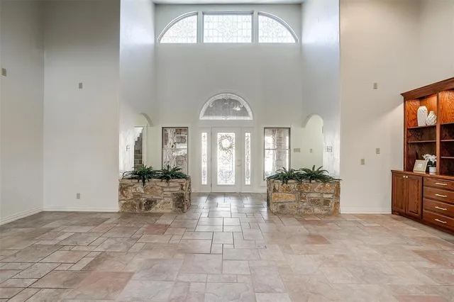 an empty room with fireplace and windows