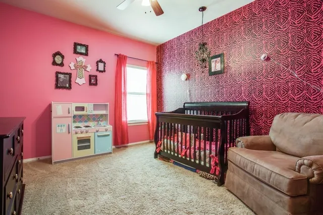 a living room with furniture a flat screen tv and a dresser