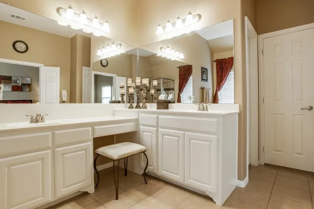 a bathroom with a sink vanity and a mirror