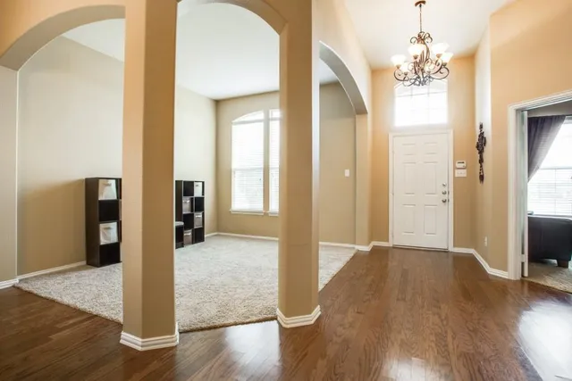 a view of a room with wooden floor