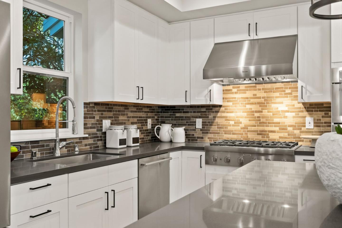275 Willow Road Menlo Park, CA 94025 - Photo 11 of 40 a kitchen with stainless steel appliances a sink stove and cabinets