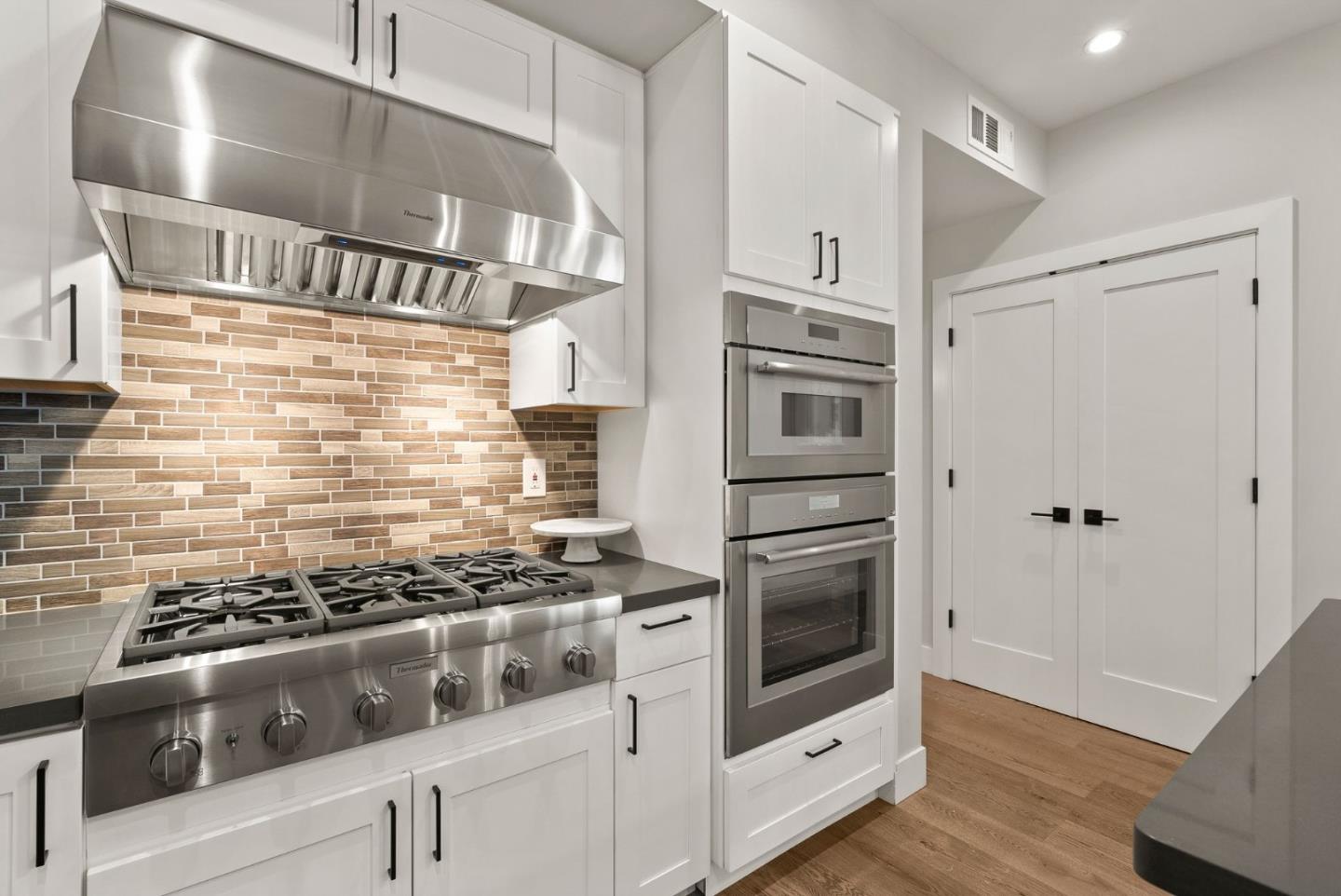 275 Willow Road Menlo Park, CA 94025 - Photo 12 of 40 a kitchen with stainless steel appliances granite countertop a stove and a refrigerator
