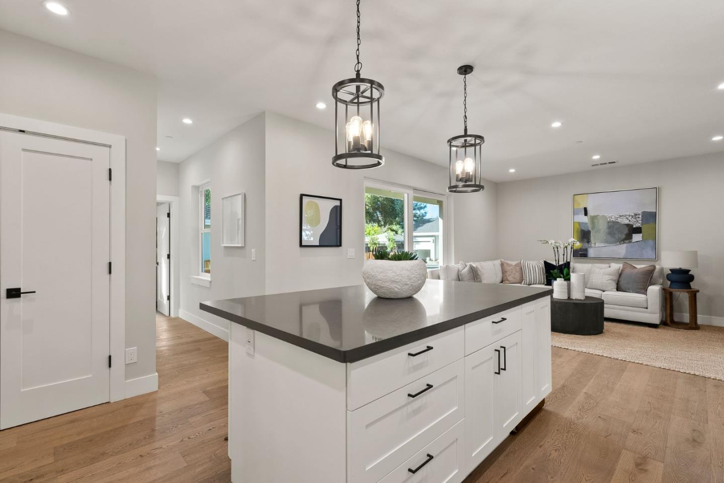 275 Willow Road Menlo Park, CA 94025 - Photo 14 of 40 a kitchen with stainless steel appliances granite countertop a sink a counter space and living room view