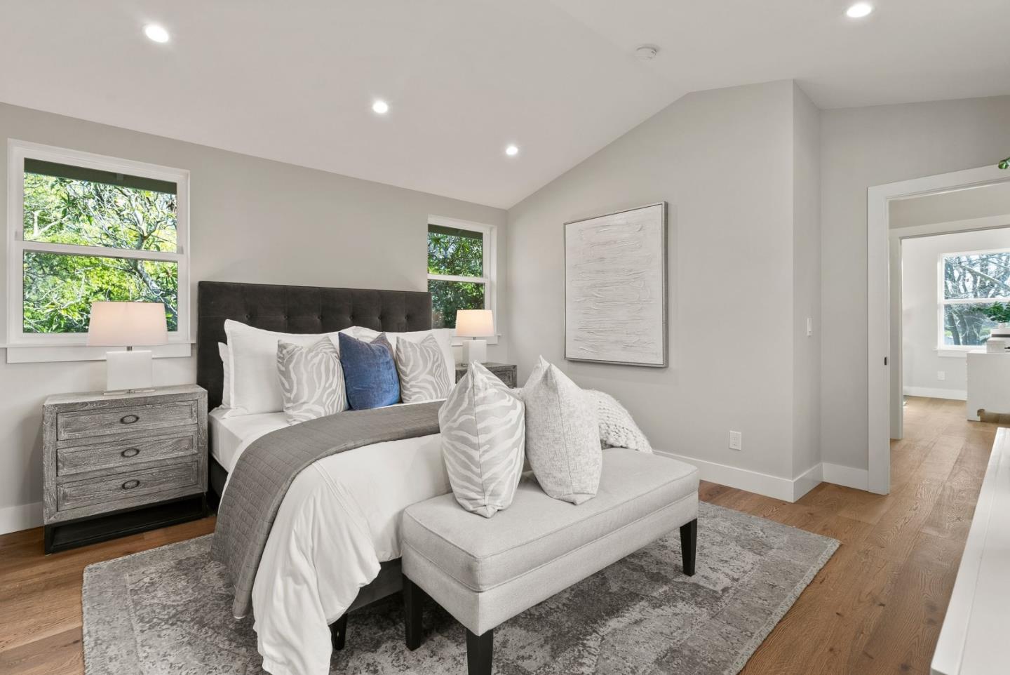 275 Willow Road Menlo Park, CA 94025 - Photo 21 of 40 a spacious bedroom with a bed and a couch