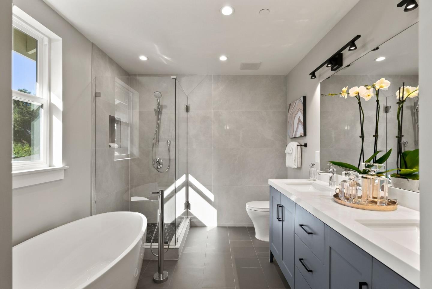 275 Willow Road Menlo Park, CA 94025 - Photo 25 of 40 a spacious bathroom with a double vanity sink toilet mirror and shower
