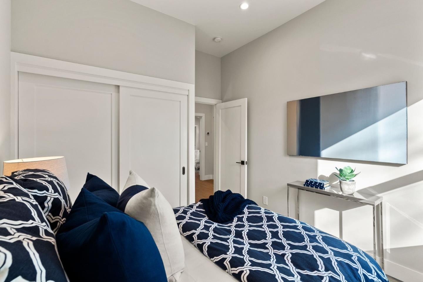 275 Willow Road Menlo Park, CA 94025 - Photo 30 of 40 a bedroom with a bed and a chandelier