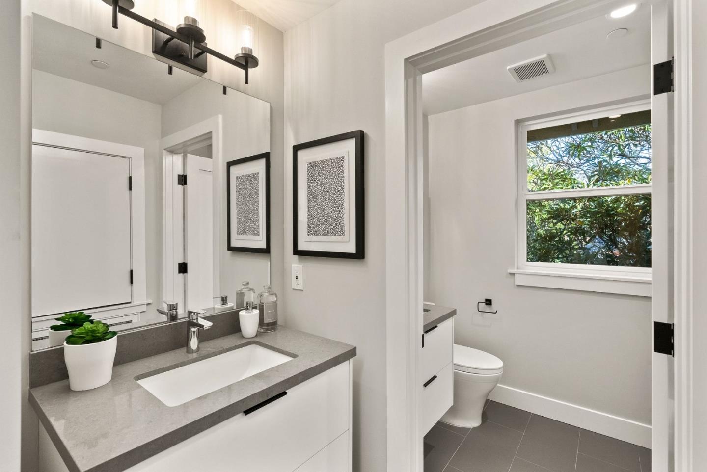 275 Willow Road Menlo Park, CA 94025 - Photo 31 of 40 a bathroom with a sink a toilet and a mirror